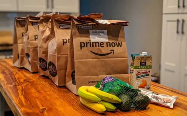 Amazon packages and groceries on a table