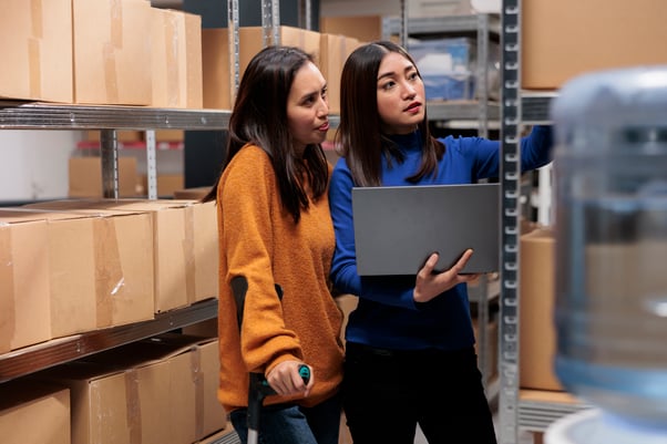 Two women in a warehouse