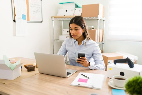 Woman checking customers orders on her online shop