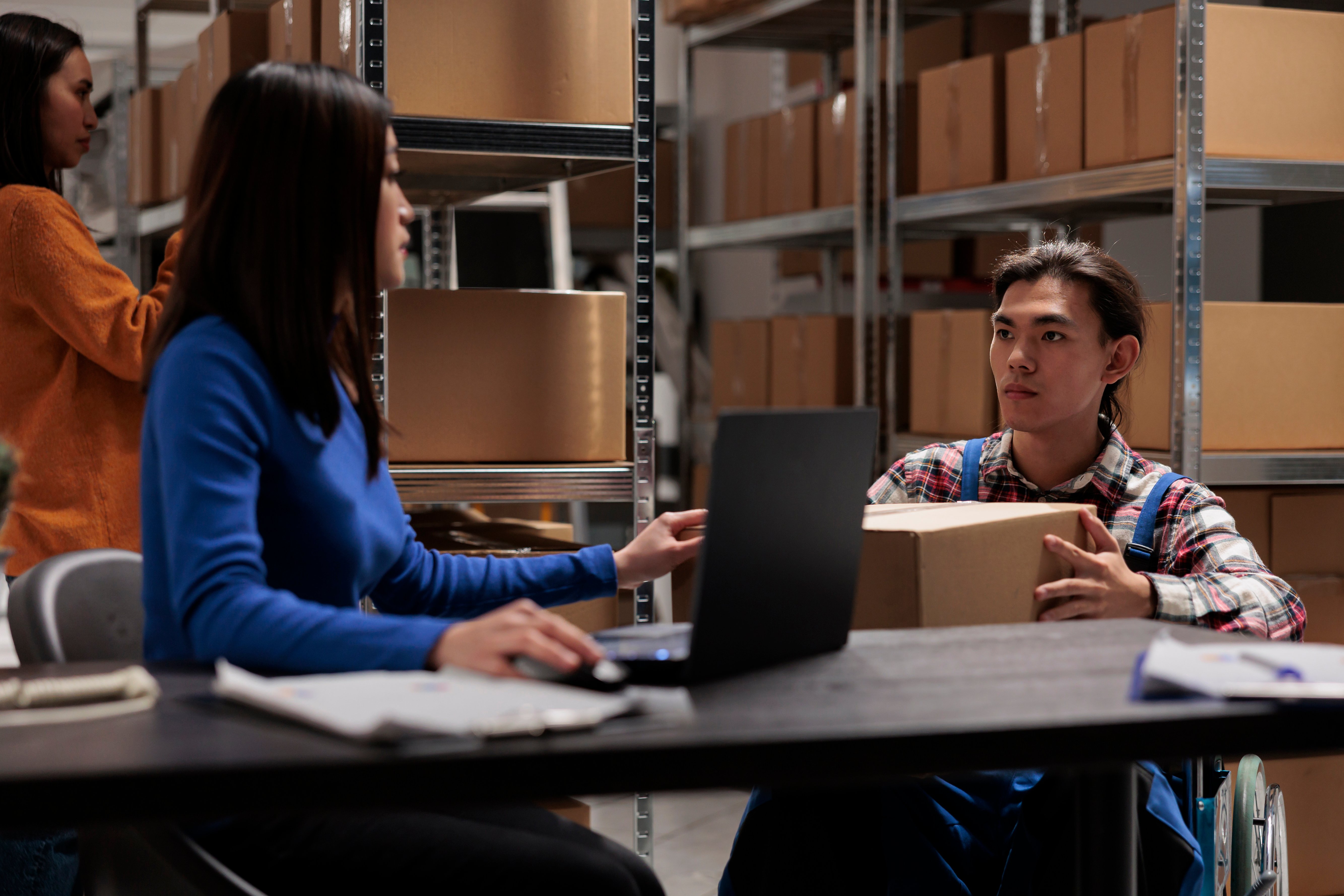 Workers managing online orders in a warehouse